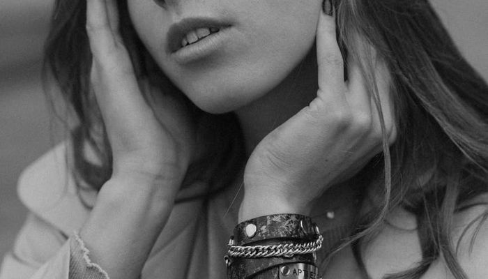 A person sitting at a clean desk, looking out the window with a relaxed expression.